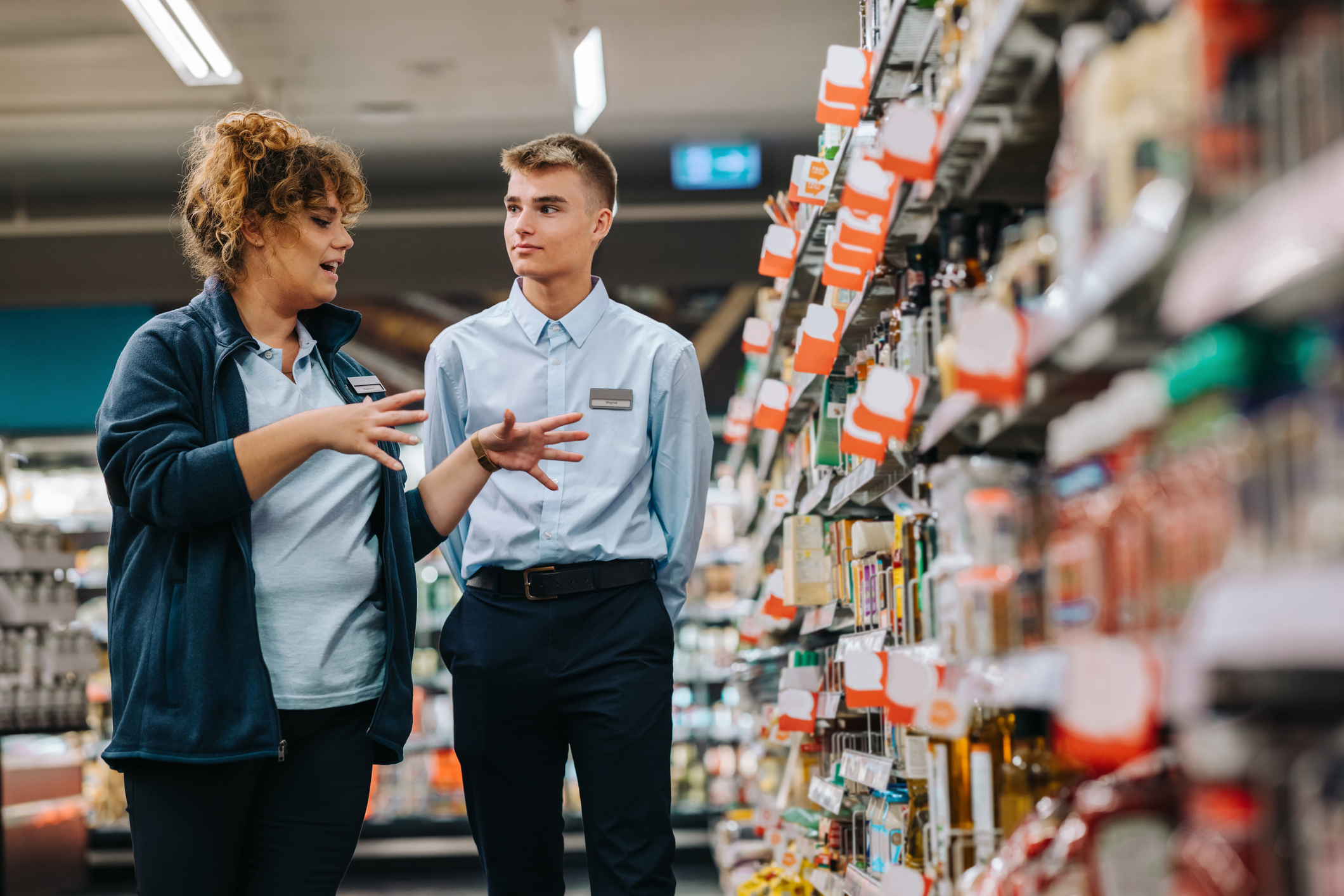 Store manager talking to employee