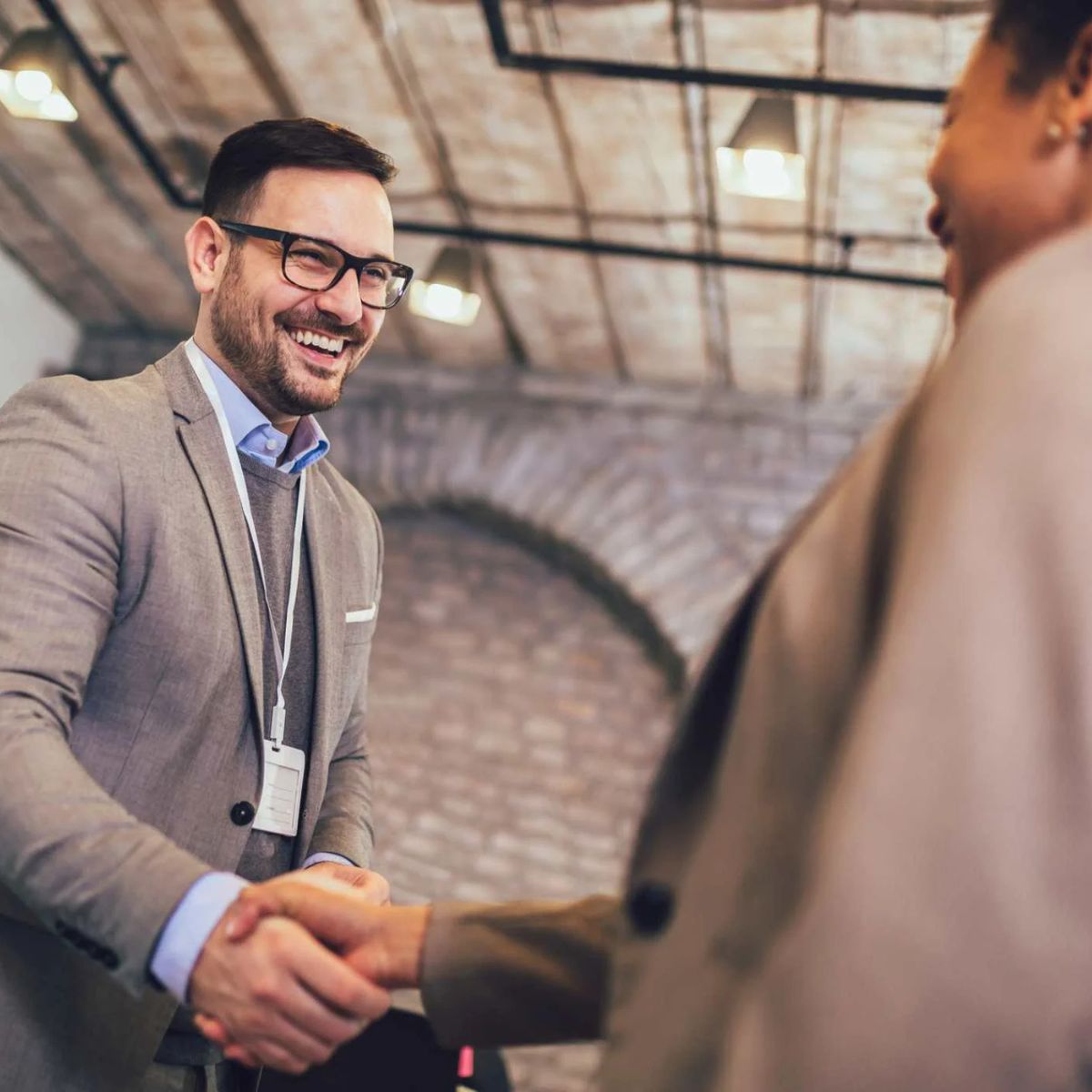 Salesman shaking women's hand