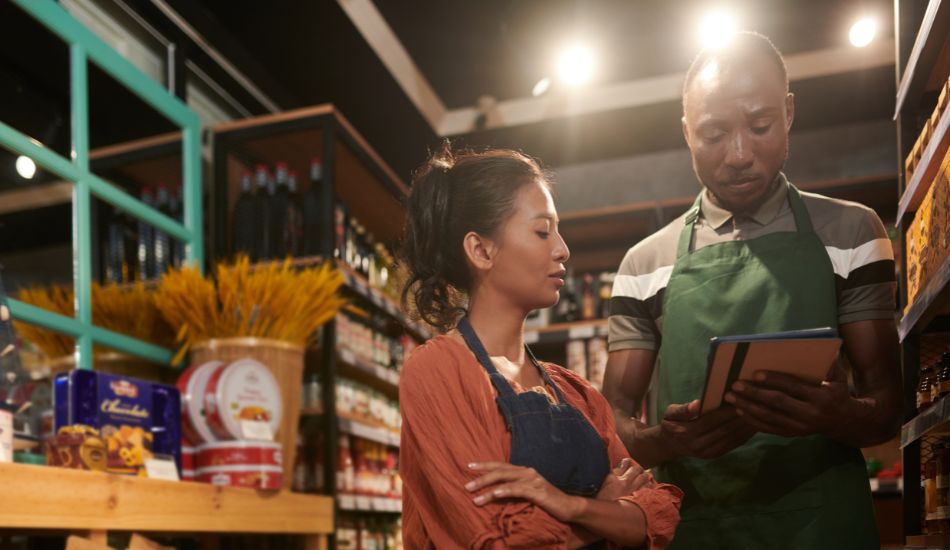 Man and Woman discussing and looking at an iPad