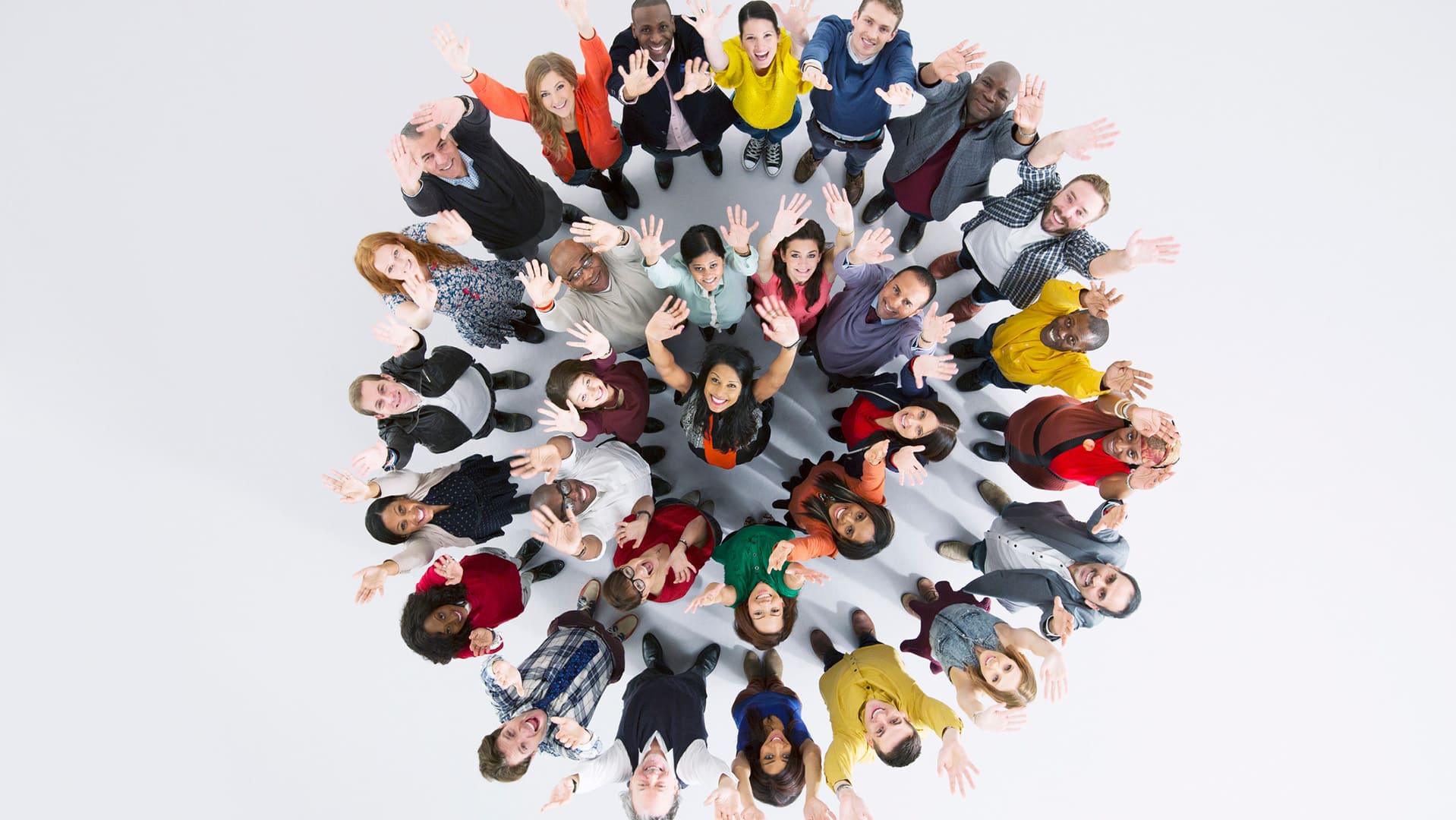 group of employees standing together with hands raised to the sky looking up
