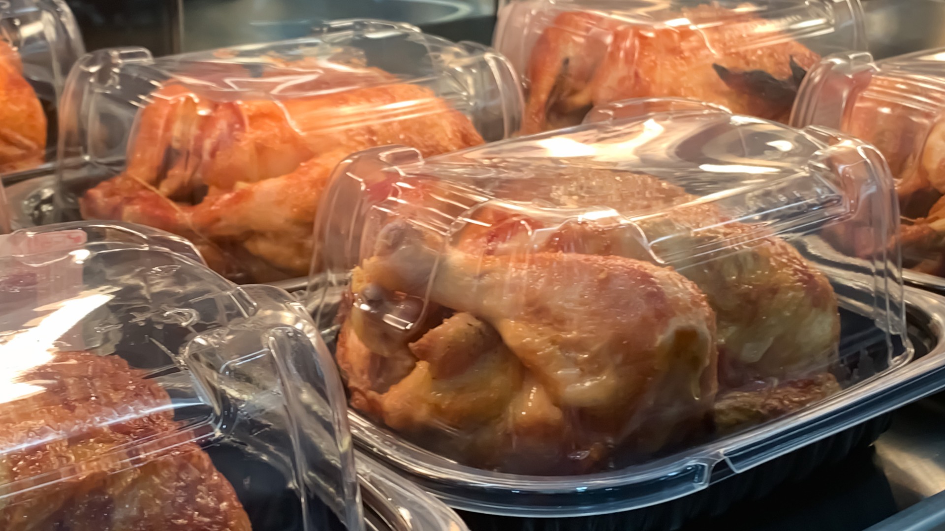 precooked chicken packaged on a grocery store heating shelf