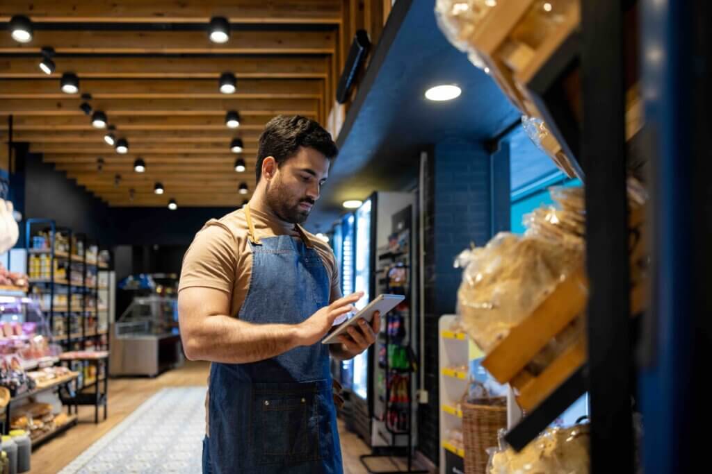 Retail clerk working at a food store and doing the inventory