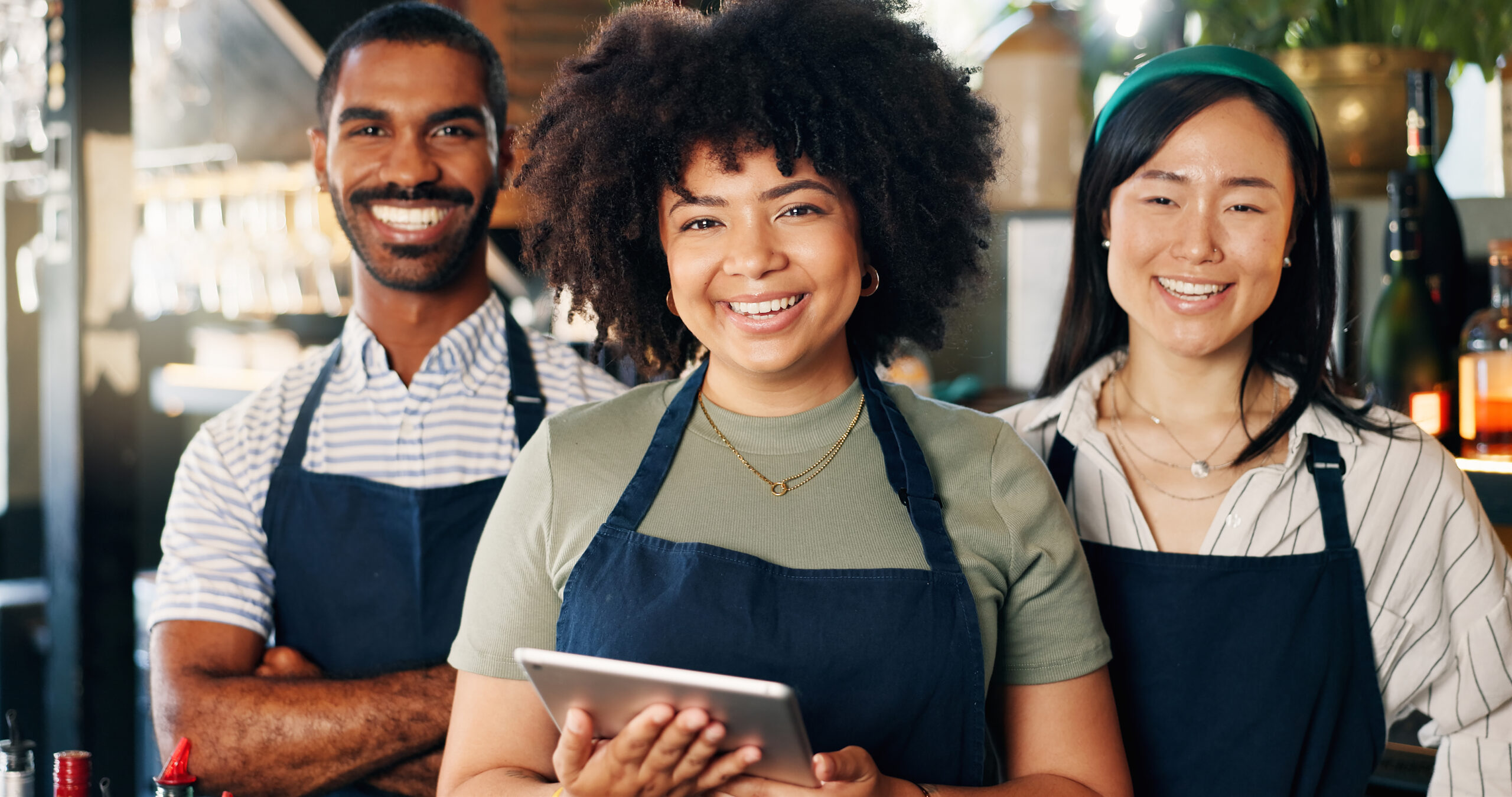 workers with ipads and aprons