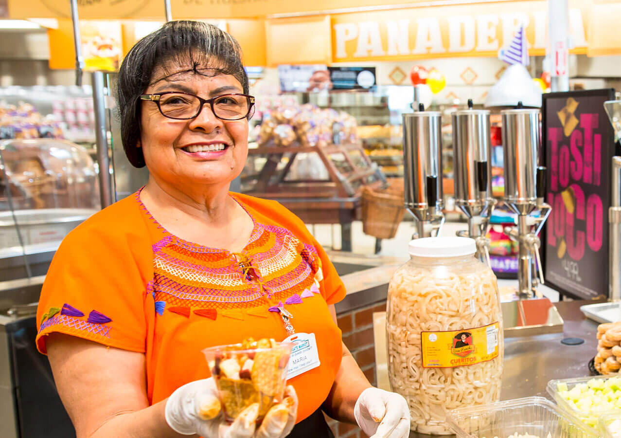 Northgate Market Employee holding food sample