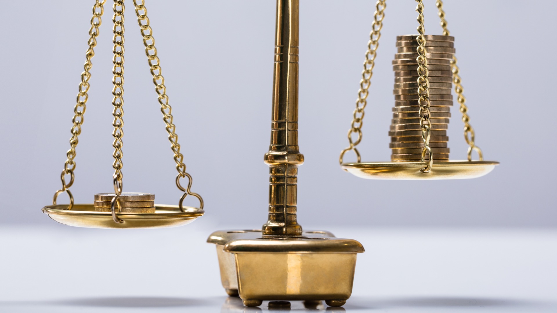 scale with coins balancing on either side