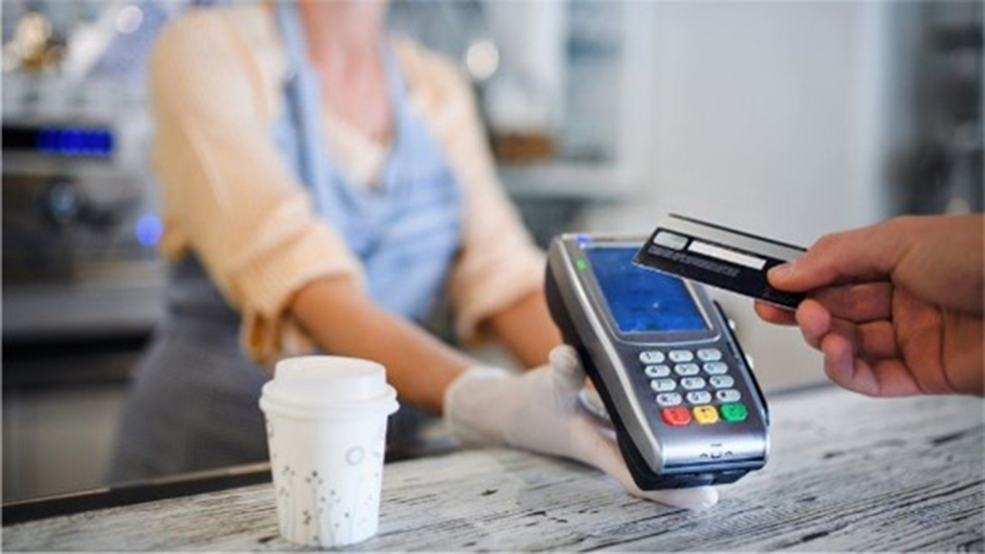 customer tapping to pay for a coffee