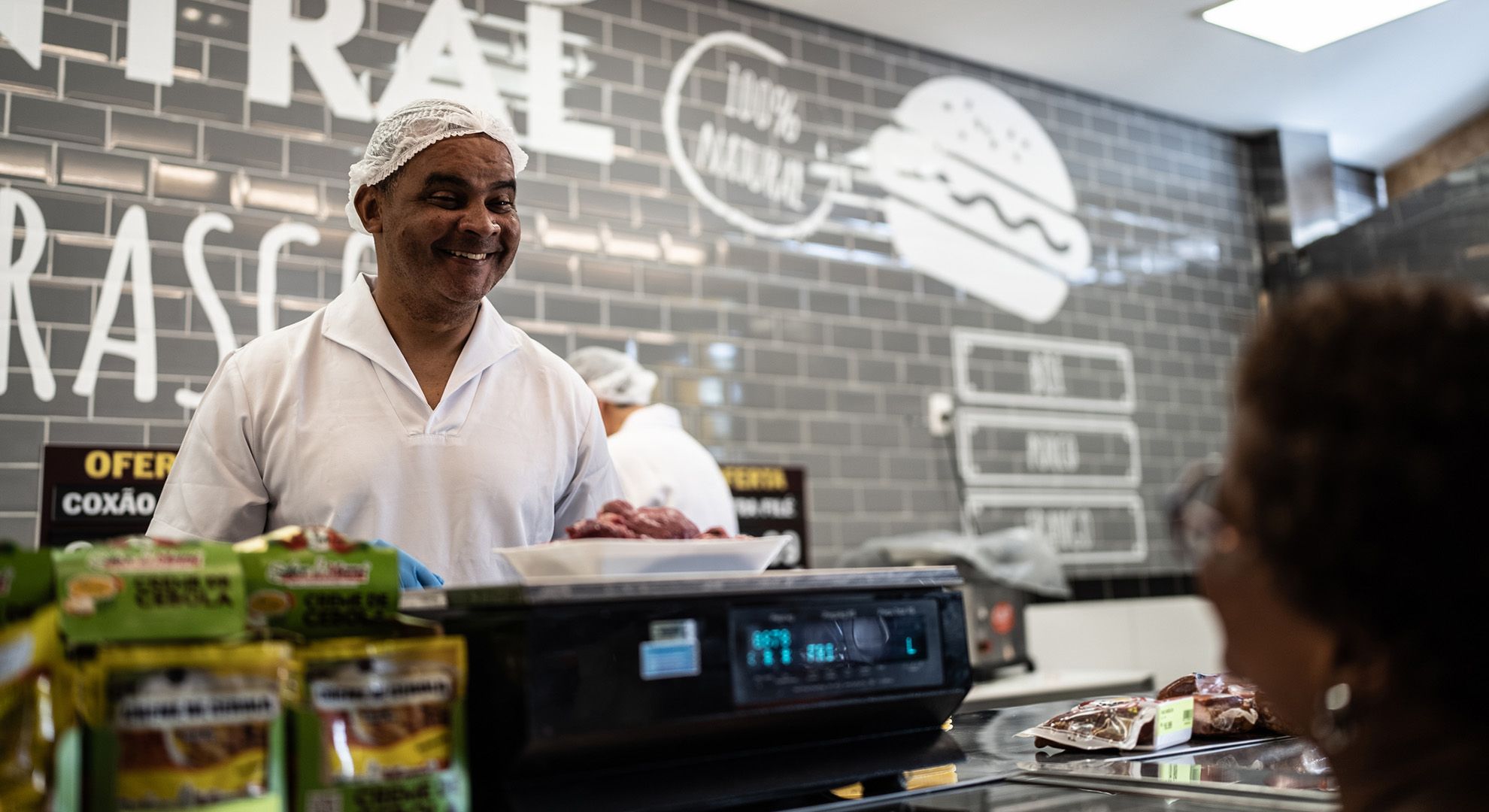 Deli counter employee helping customer