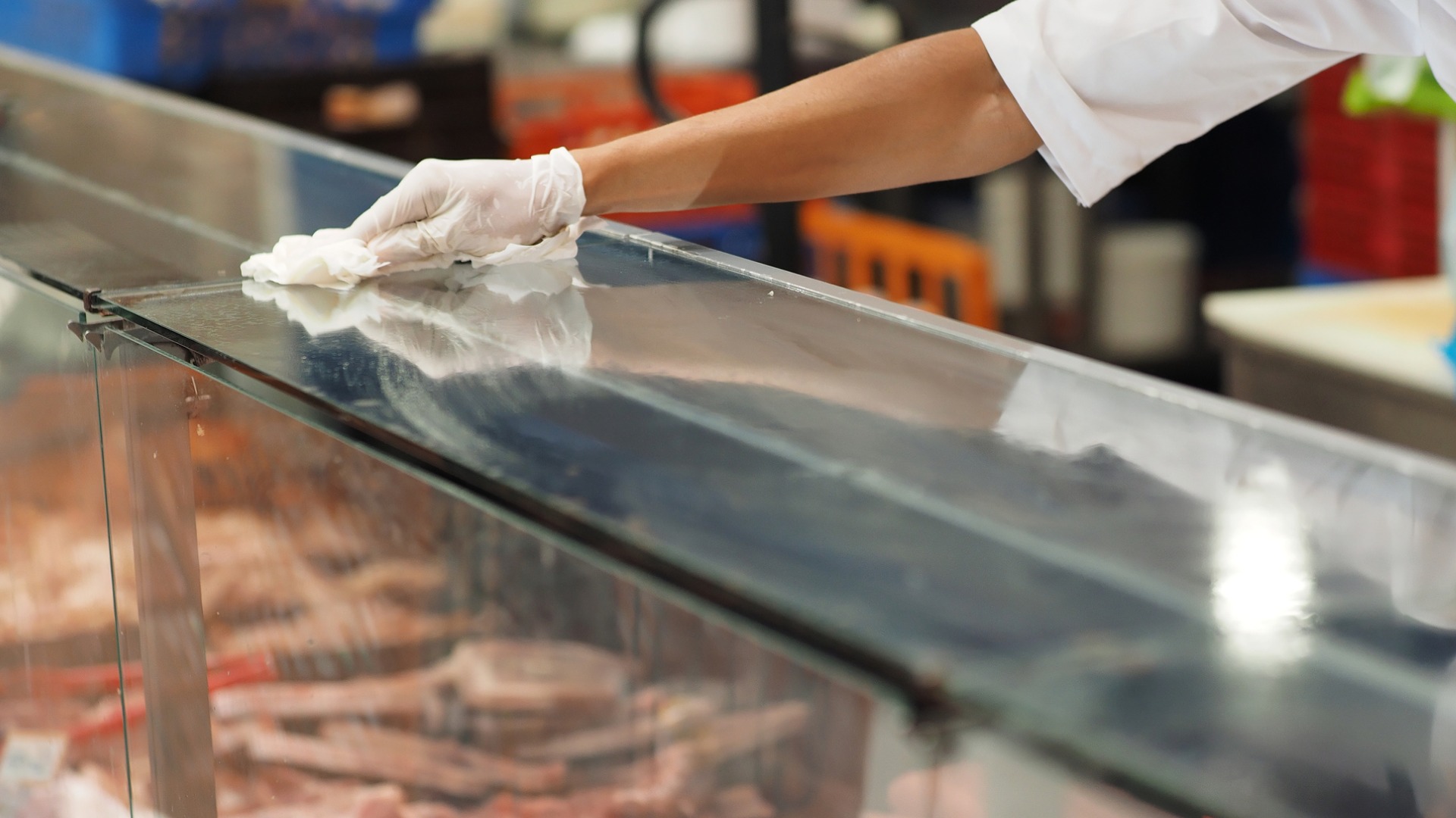 employee wiping down countertop
