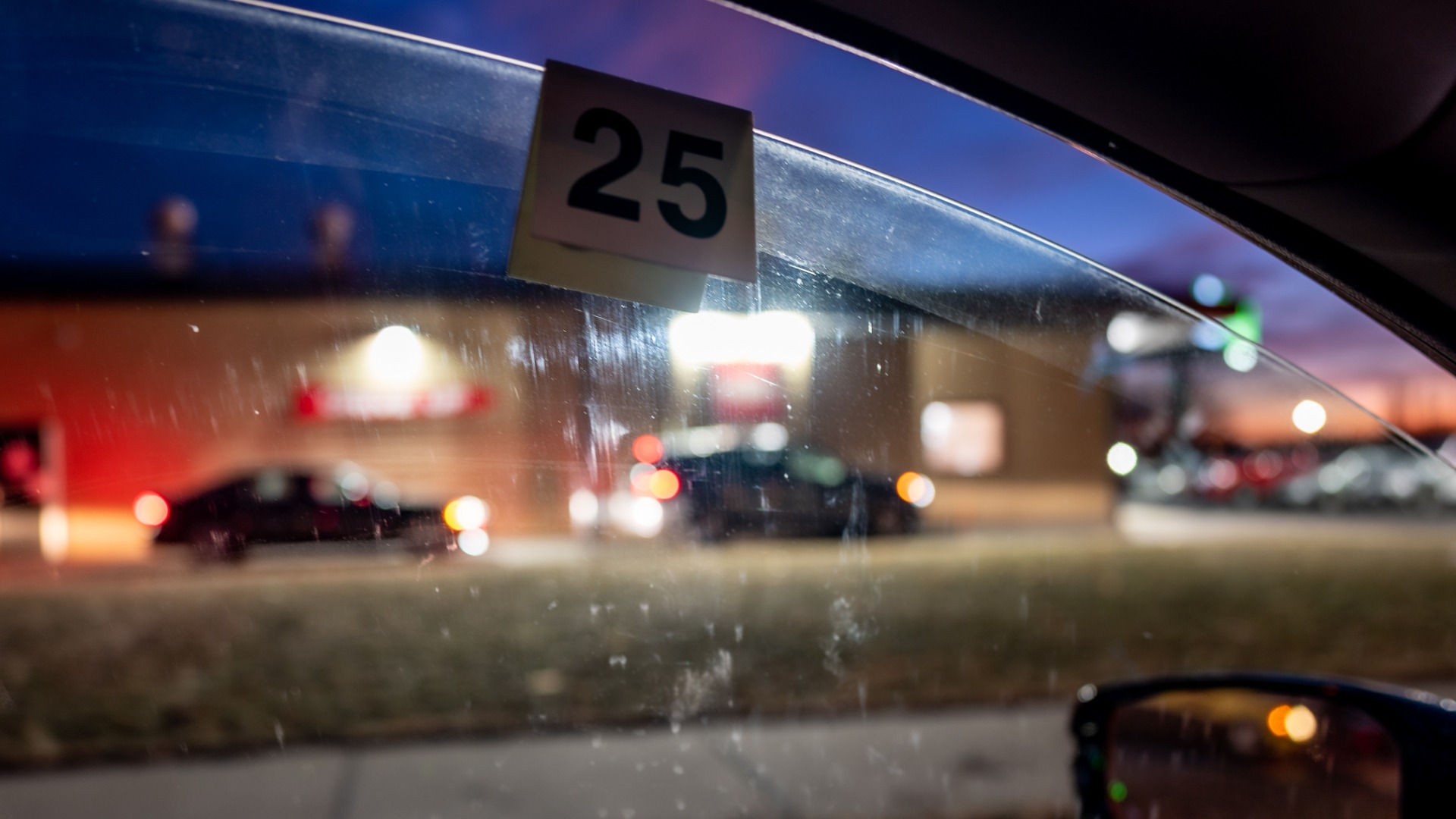 open car window with number 25 tag hanging