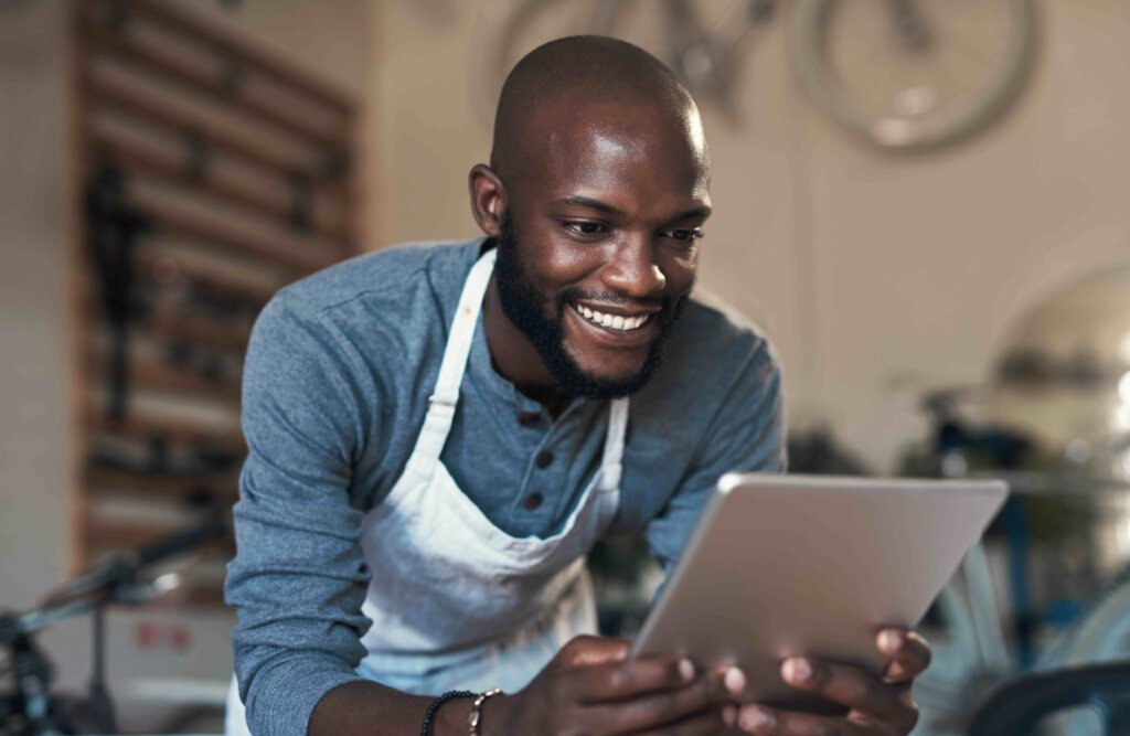 Man smiling and using a tablet