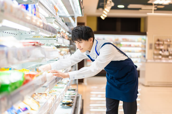 employee stocking prepared food aisle