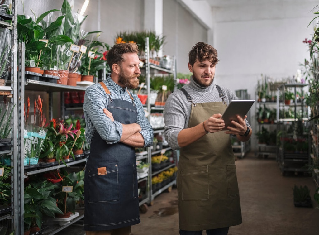 two men in a store looking at ipad
