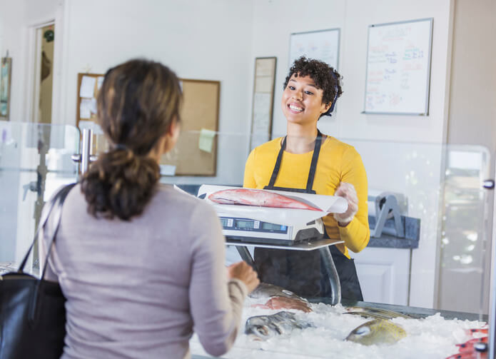 seafood specialist helping customer