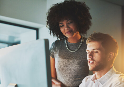 Shot of two young designers working together on a computer in the office